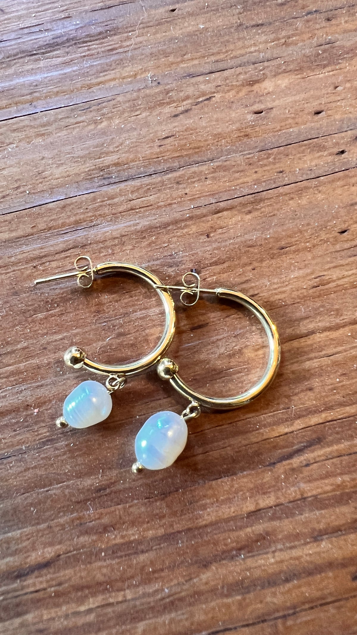 Gold earrings combined with a pearl