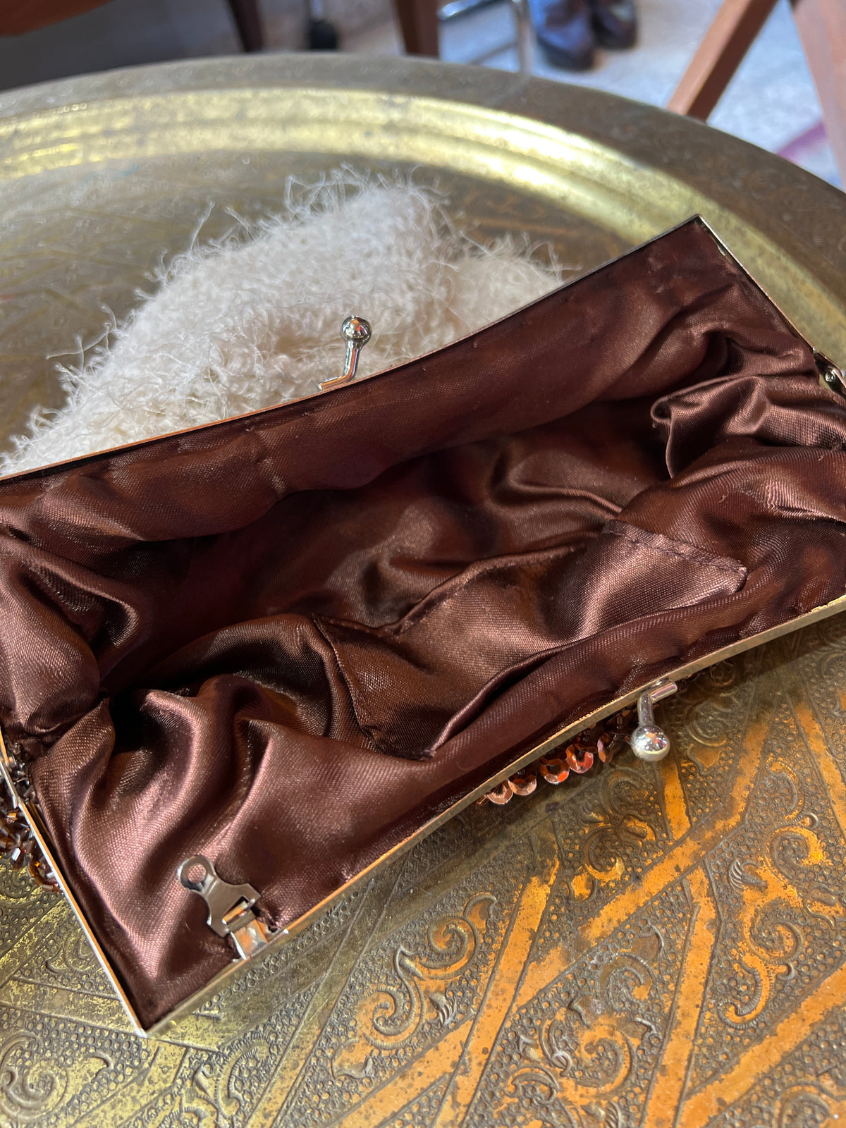 An antique brown beaded clutch entirely hand-sewn