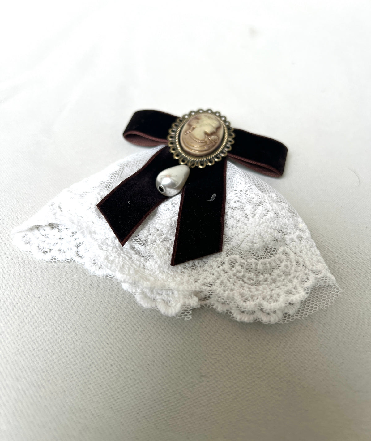A burgundy bow tie pin for a retro design garment