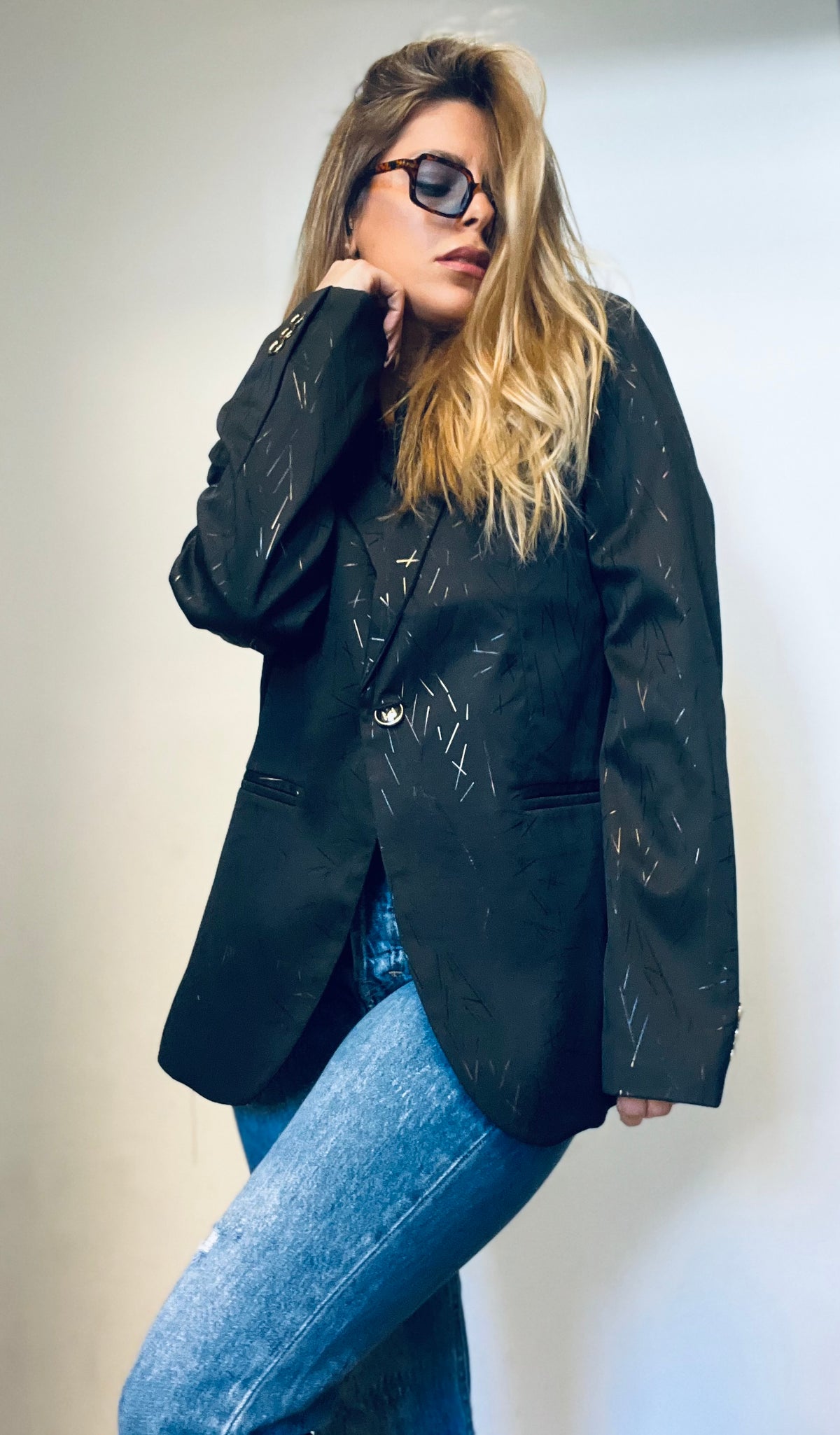 A black blazer with gold touches