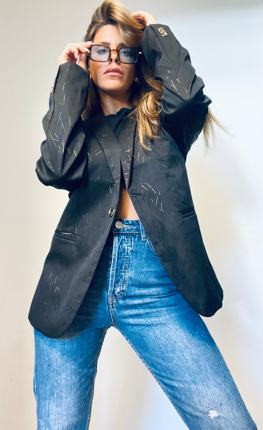A black blazer with gold touches