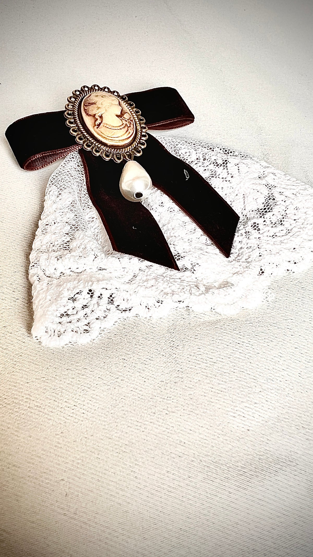 A burgundy bow tie pin for a retro design garment