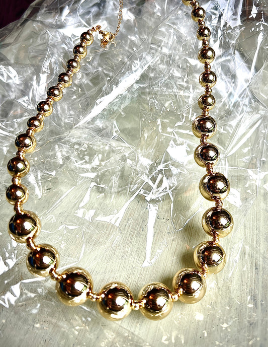 A necklace of round gold beads
