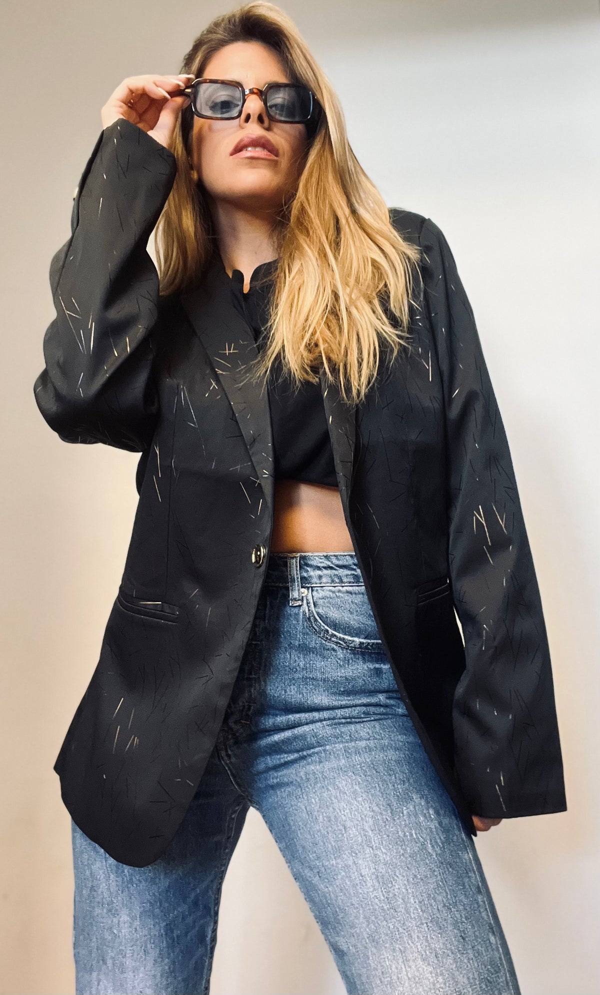 A black blazer with gold touches