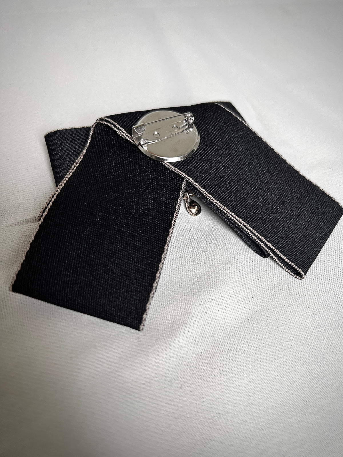 Black bow tie pin for a retro design garment
