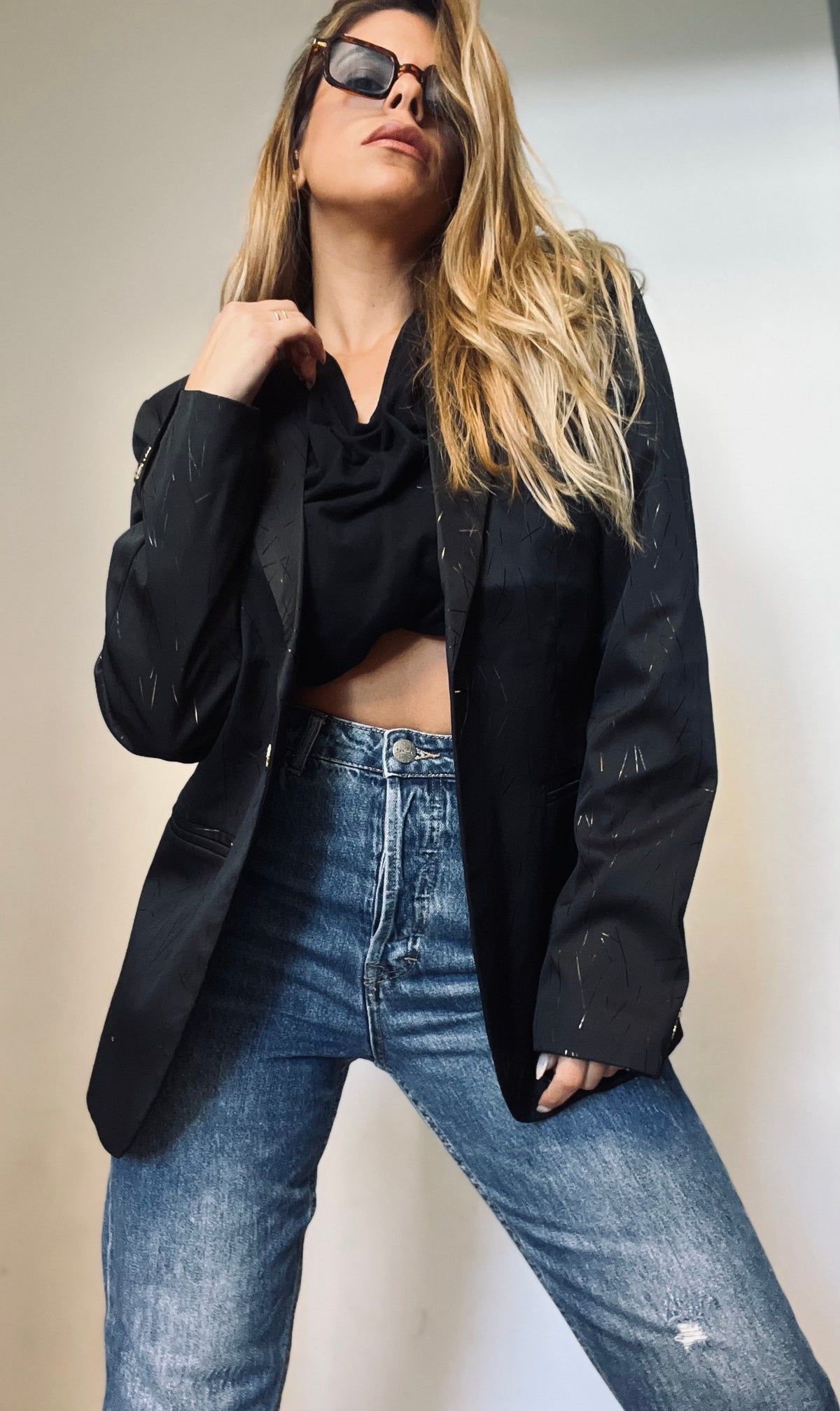 A black blazer with gold touches
