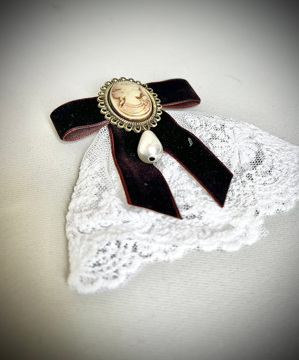 A burgundy bow tie pin for a retro design garment