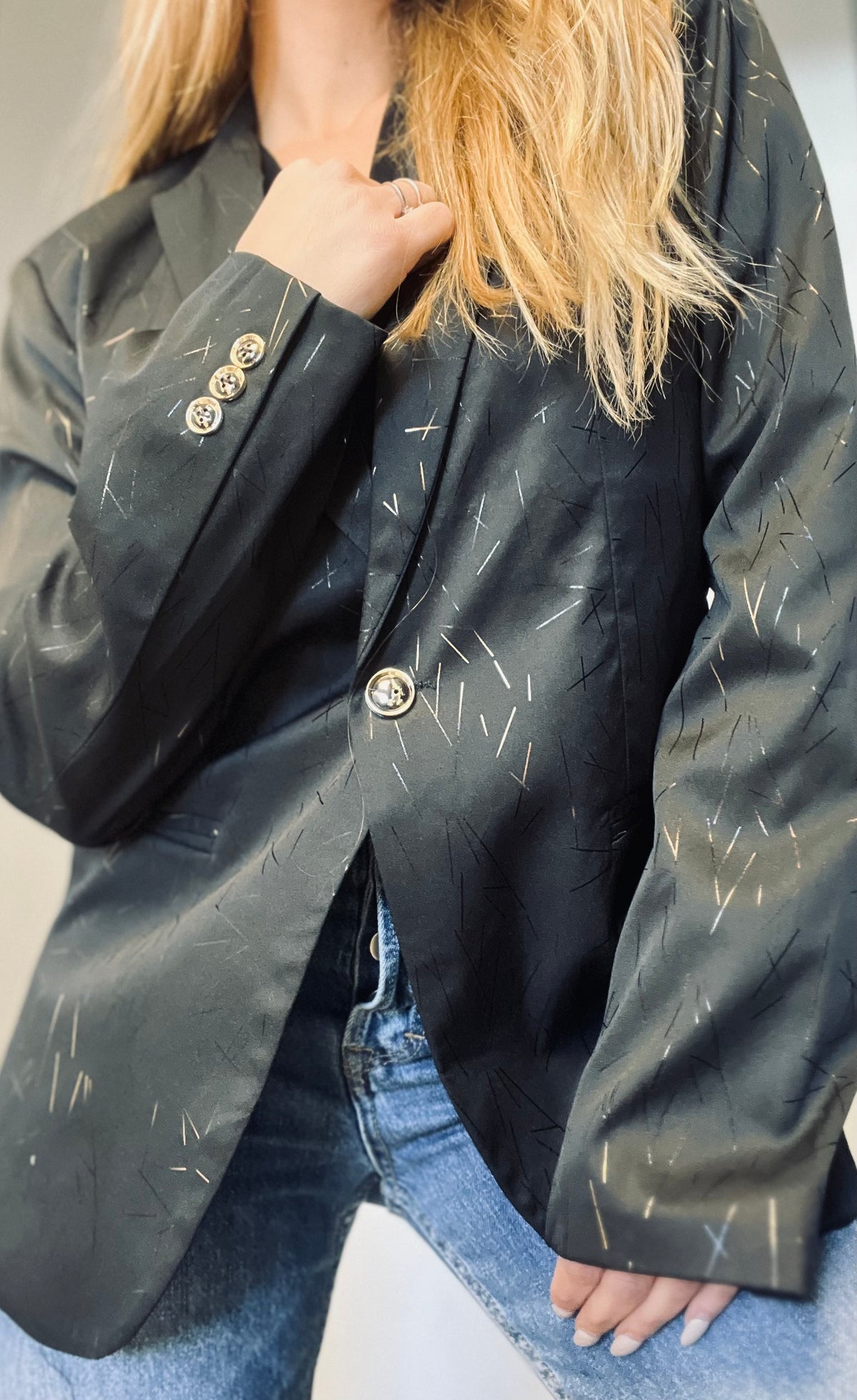 A black blazer with gold touches