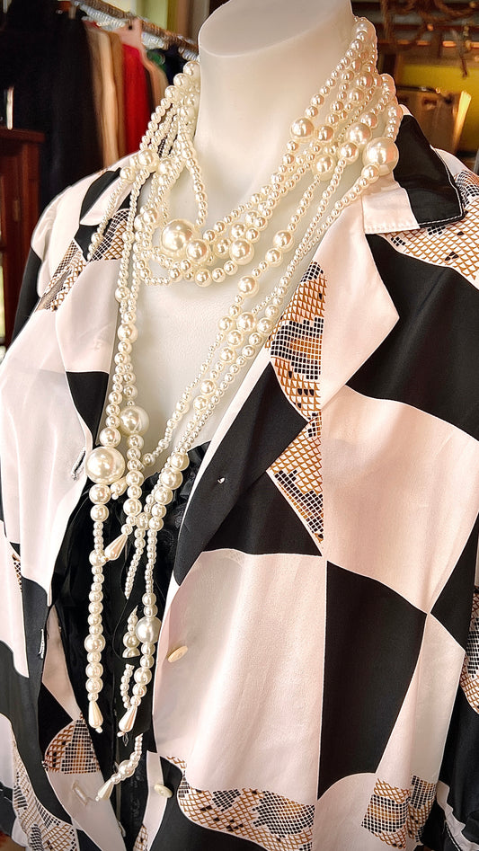 A combination of pearl necklaces are attached and tied