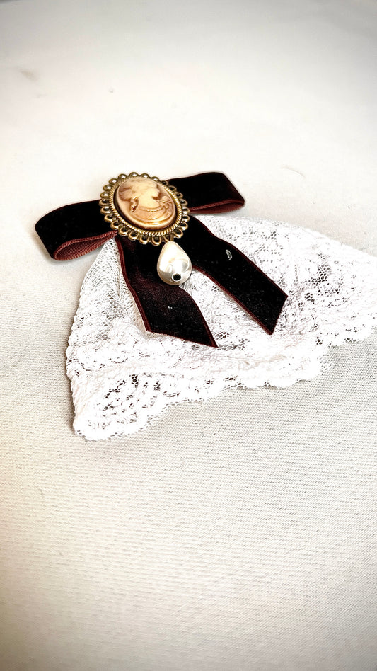 A burgundy bow tie pin for a retro design garment